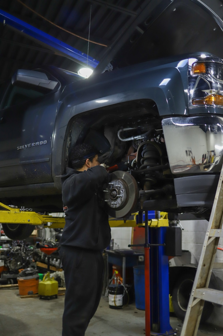 Tony Automotive technician performing brake service on a pickup truck